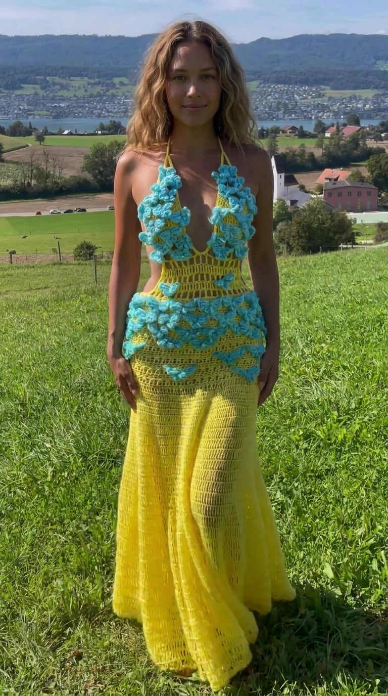 Front view of model wearing vibrant yellow halter crochet maxi dress with turquoise 3D floral appliques